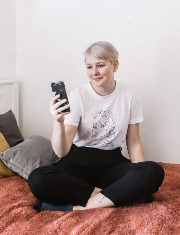 Young Woman looking for a Flat using her mobile phone